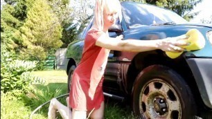 Sexy trans-girl car washing in red snoopy dress. Wetlook red dress
