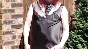Redhead crossdresser strip from black satin