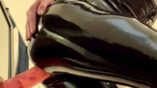 Stacy in latex riding a huge dildo
